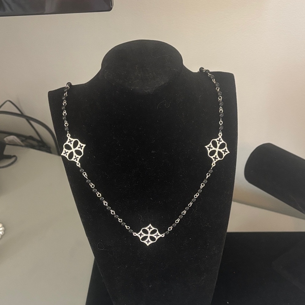 Silver chain and small black beads necklace.